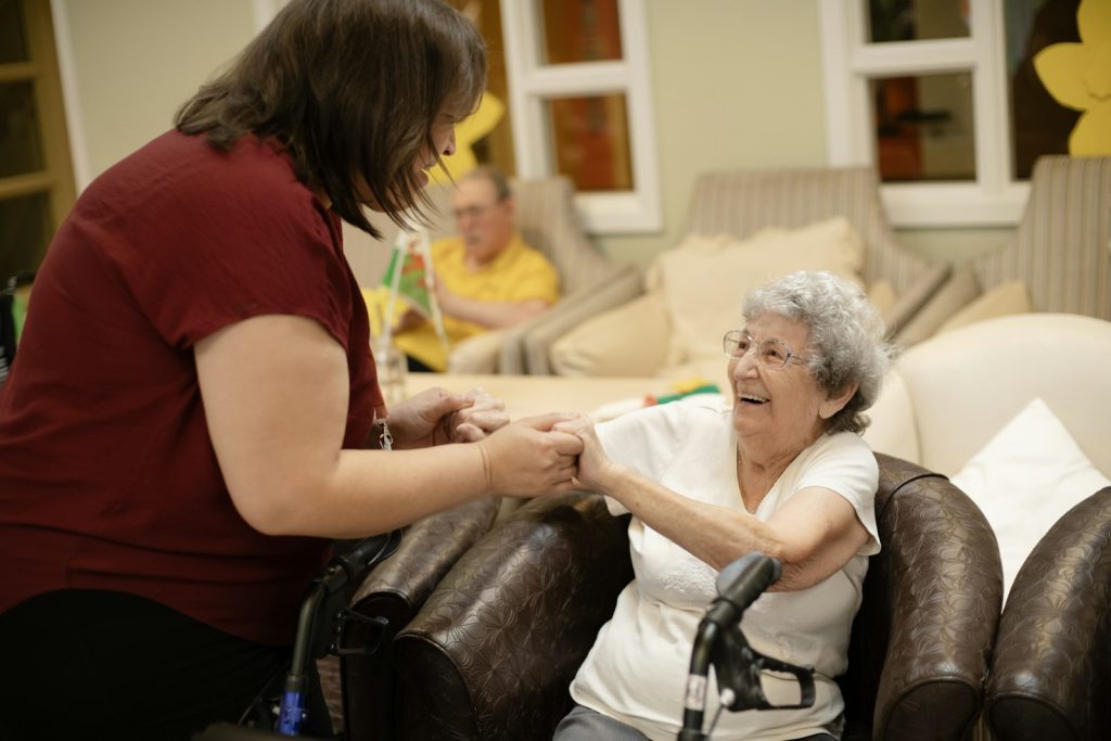 Carer supporting an aged care resident