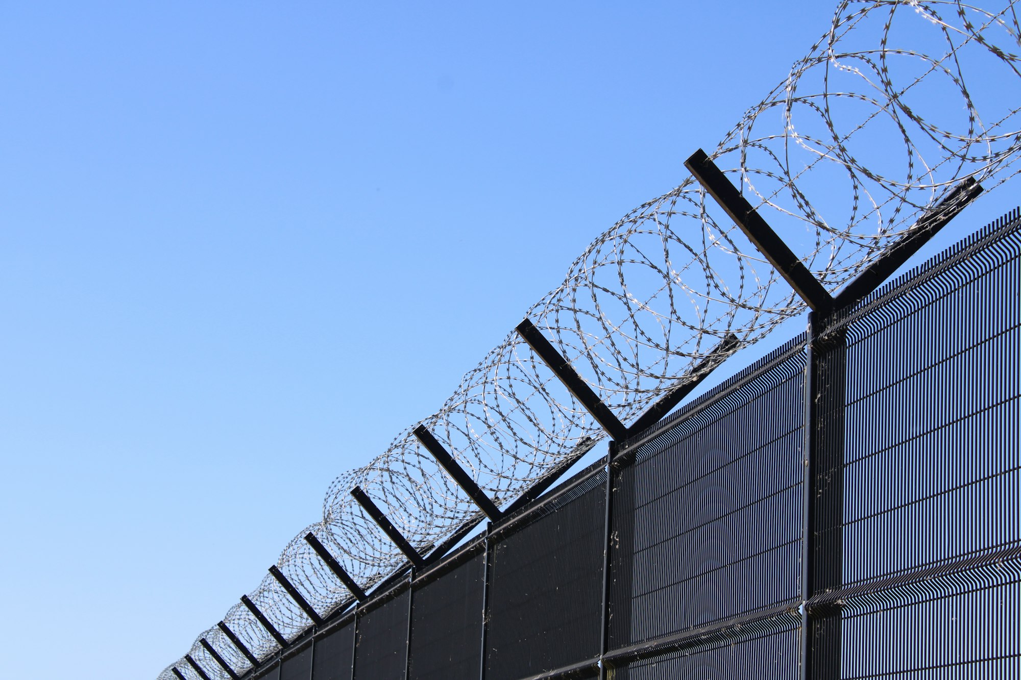 Razor wire on a high security fence, an example of a physical control in a CIRMP physical security plan
