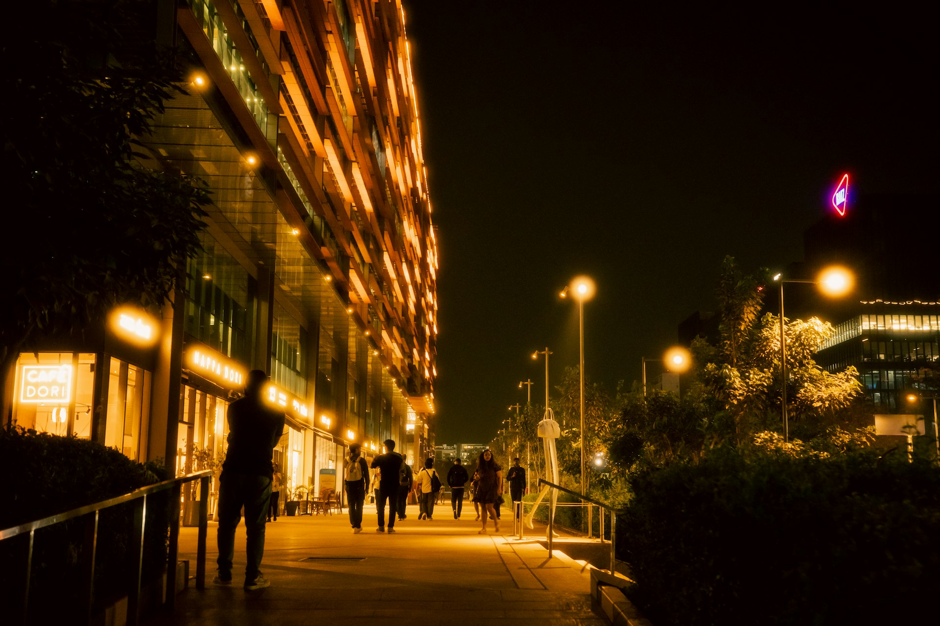 Lit pedestrian pathway beside active building frontages, showing CPTED natural surveillance
