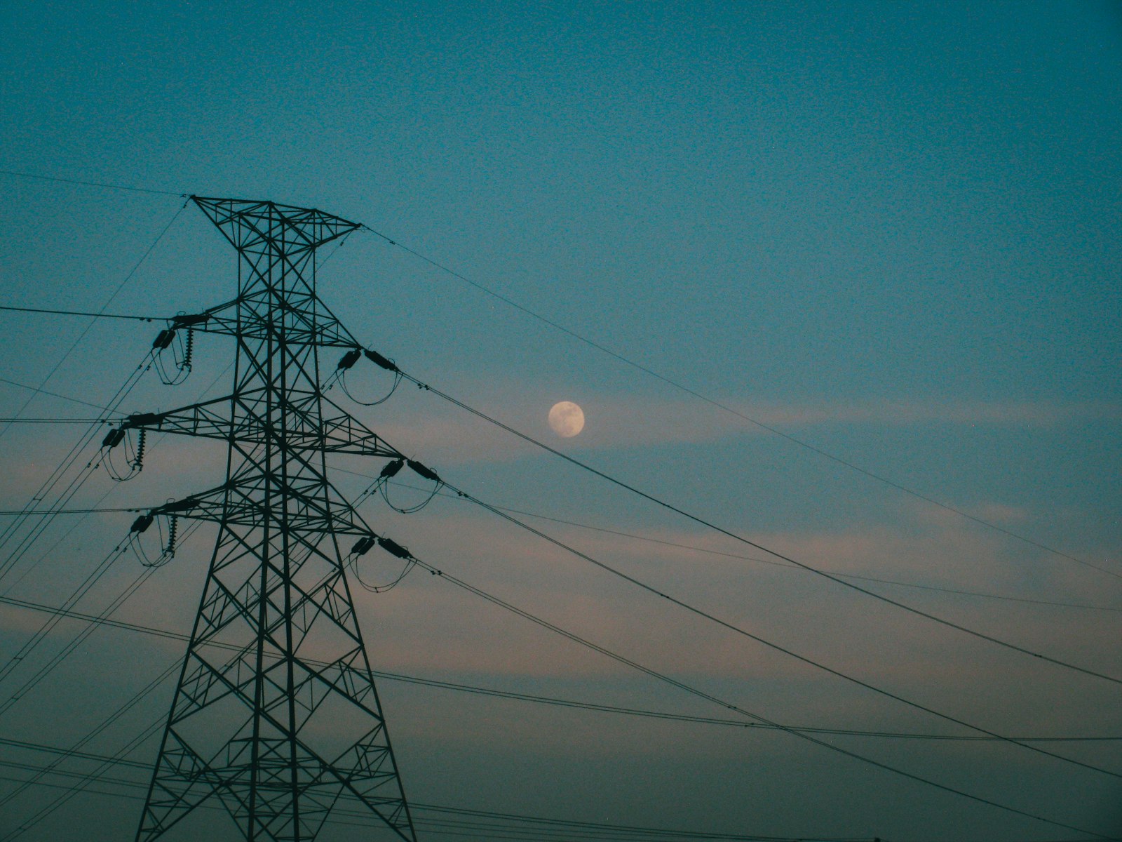 Electricity transmission tower at dusk