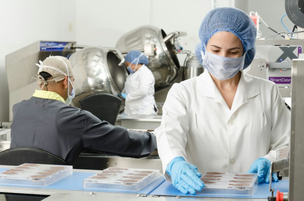 Pharmaceutical production staff in protective clothing