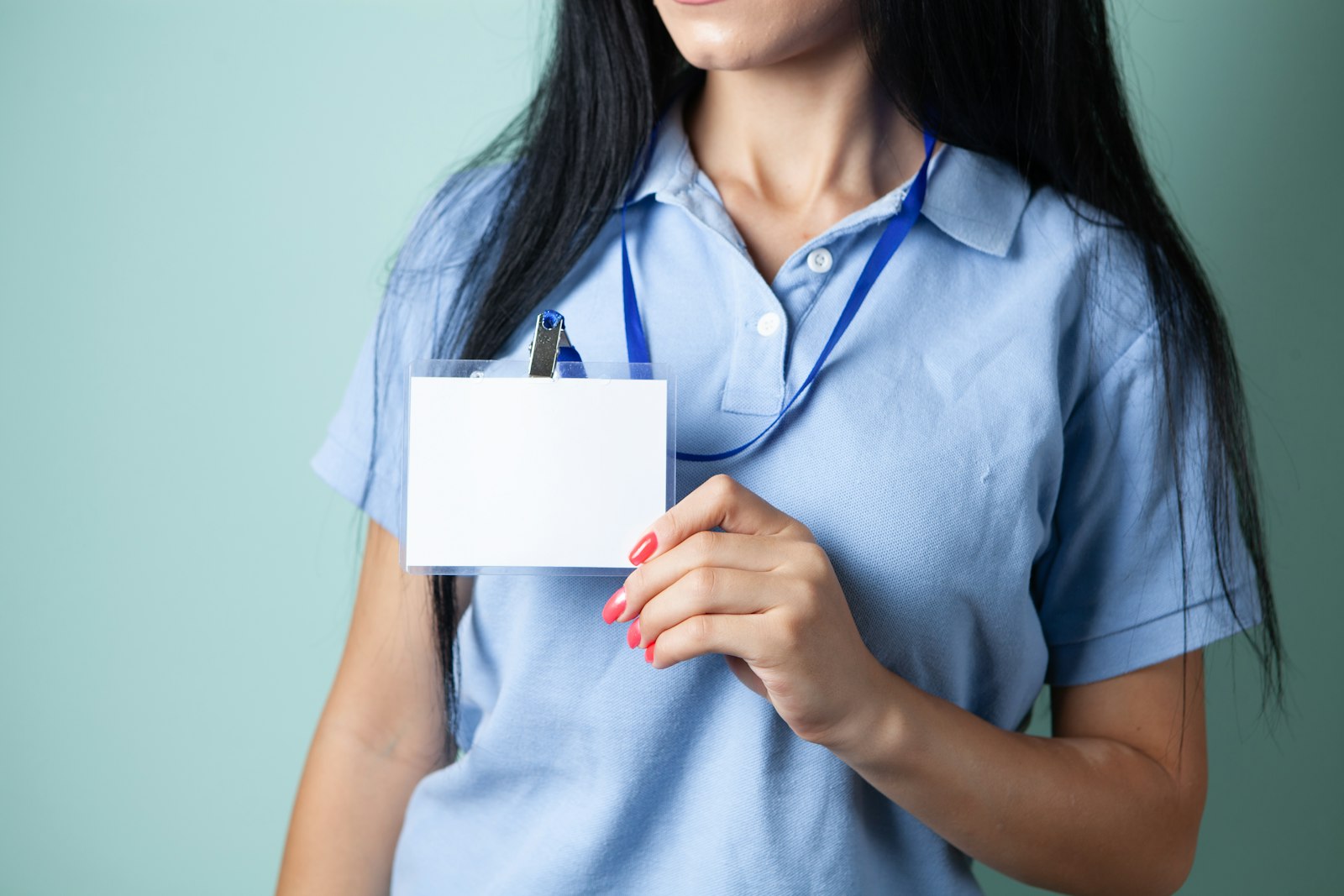 Staff member holding an identification badge, the kind of credential controlled under CIRMP personnel security requirements